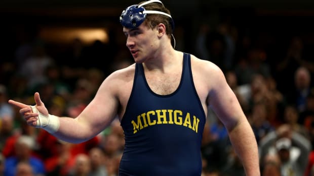 Michigan Wolverines wrester Adam Coon (green) reacts after being defeated by Ohio State Buckeyes wrestler Kyle Snyder (red) during the NCAA Wrestling DI Wrestling Championships at Quicken Loans Arena.